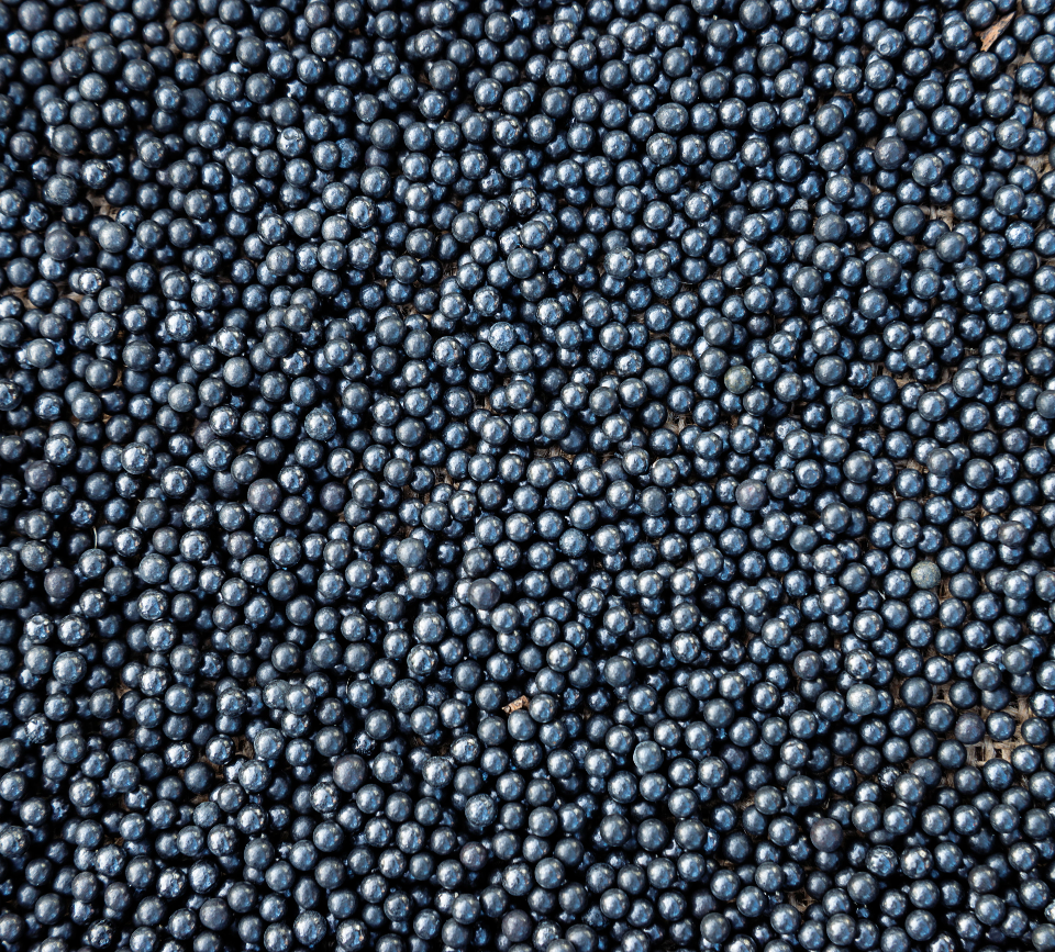 Close-up of blueberries densely packed together, showing dark blue color and light bloom